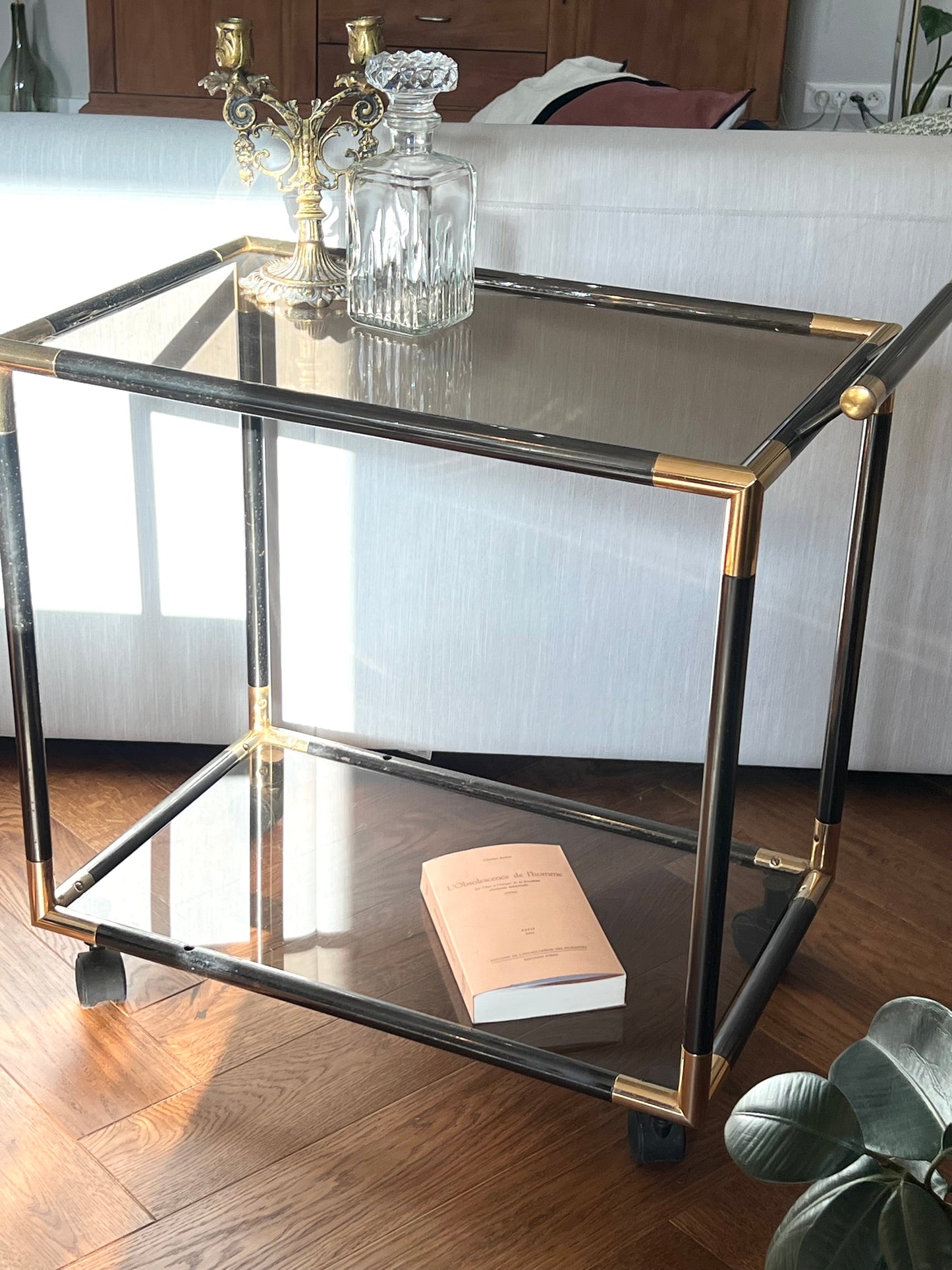Desserte années 70, deux vitres en verre fumé, métal noir et doré, rouillé à quelques endroits, bon état général.
